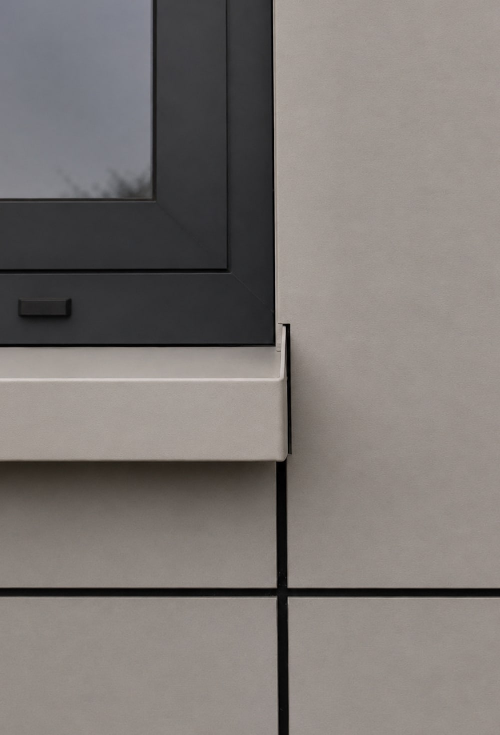 Detail of the precise junction between a window, sill and facade