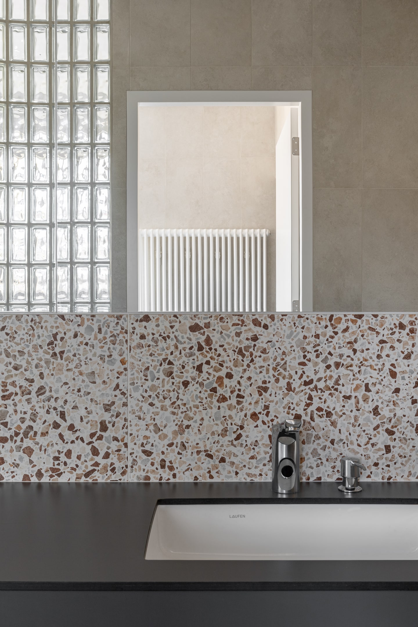 Bathroom detail with terrazzo tiles and glass blocks