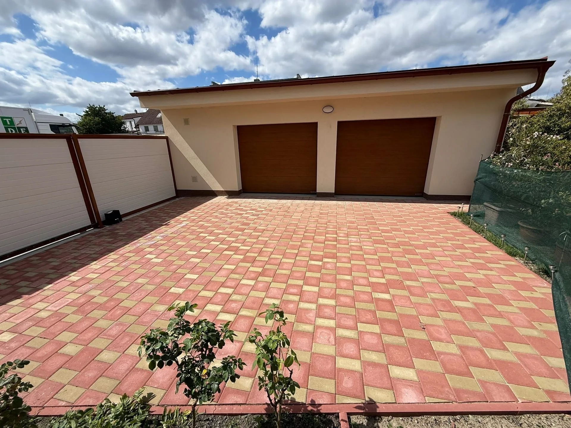 Completed double garage with a paved driveway